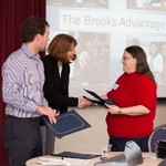 Two women shaking hands during certificate presentation